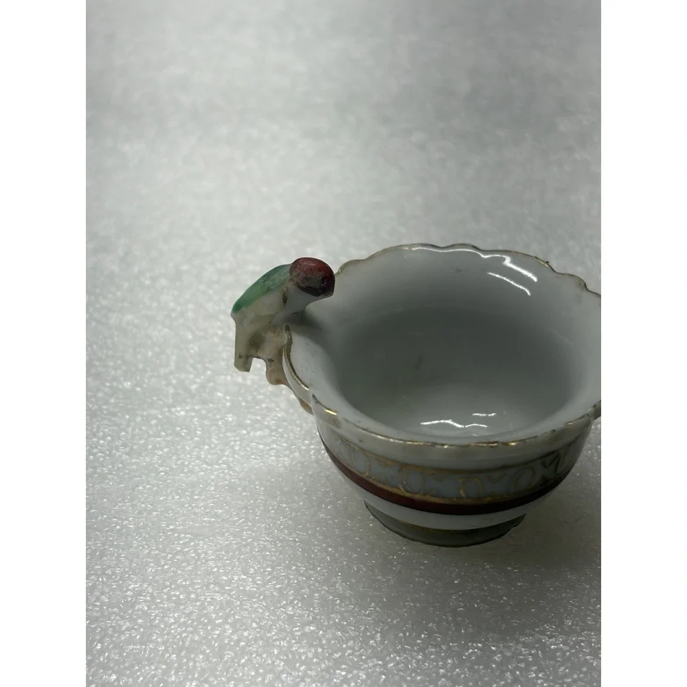 Vintage porcelain child's teacup with parrot bird handle Japan